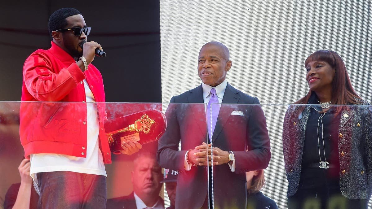 Sean "Diddy" Combs holds up the key to New York City at a ceremony alongside Mayor Eric Adams