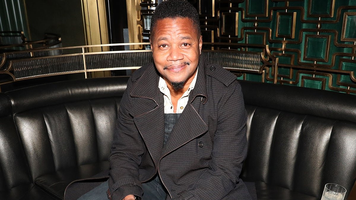 Cuba Gooding Jr. wears black trench coat