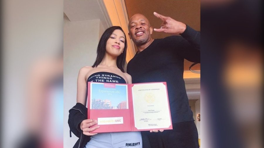 Dr. Dre's poses with his daughter, Truly Young, as she holds her acceptance letter to USC. (Credit: Dr. Dre/Instagram via CNN)