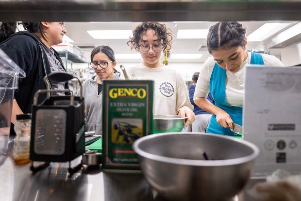 Students prepare food during a cooking clinic at Sherman Oaks...