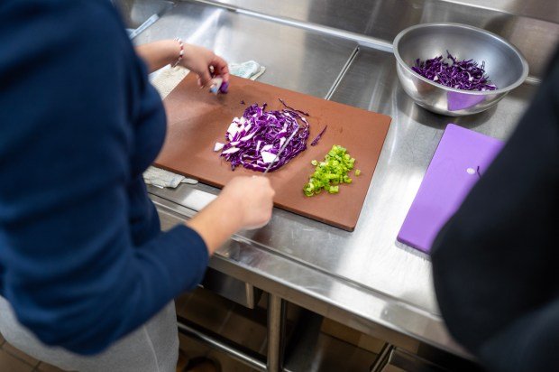 Students prepare food during a cooking clinic at Sherman Oaks...