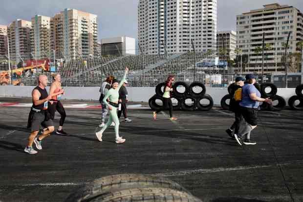 Runners and walkers replace IndyCars on the race course on...