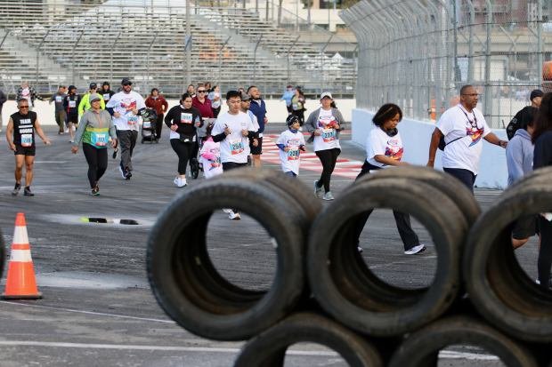 Runners and walkers replace IndyCars on the race course on...