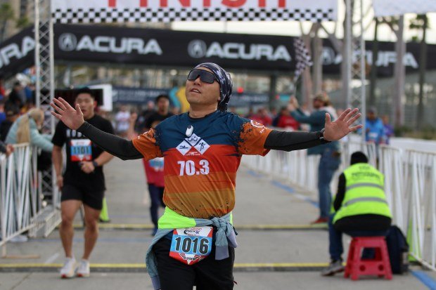 Participants reach the finish line on Sunday, Apr. 14, 2024,...