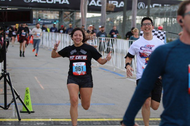 Participants reach the finish line on Sunday, Apr. 14, 2024,...