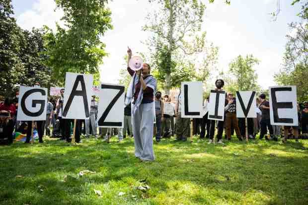 Monique, of ANSWER Coalition, leads chants as Pro-Palestinian students and...