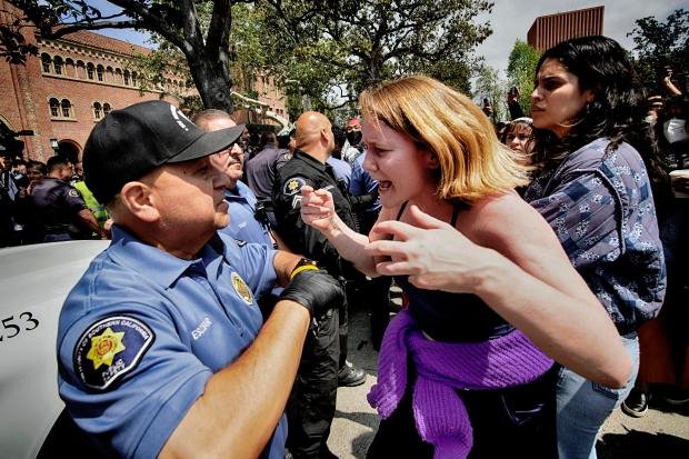 A University of Southern California protester, right, confronts a University...