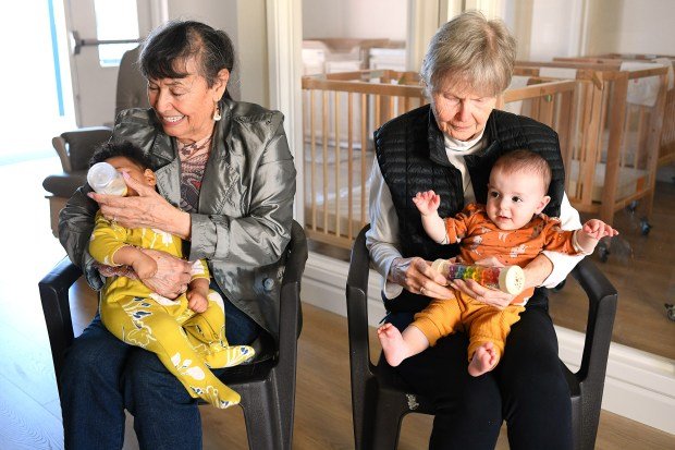 Margarita and Janine (l-r) spend time with babies Makayla and...