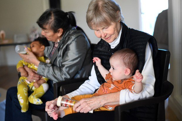 Margarita and Janine (l-r) spend time with babies Makayla and...