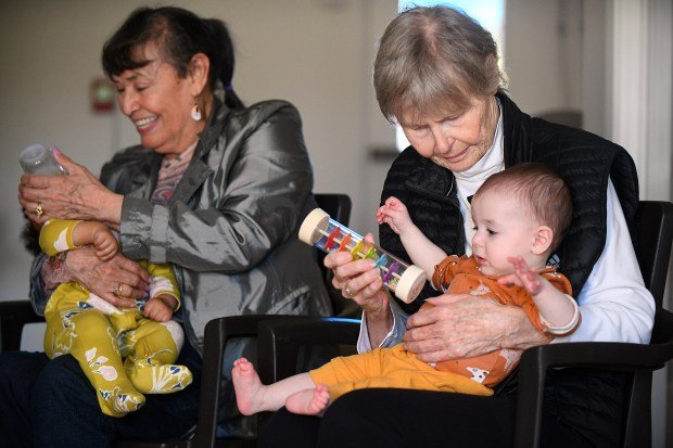 Margarita and Janine (l-r) spend time with babies Makayla and...