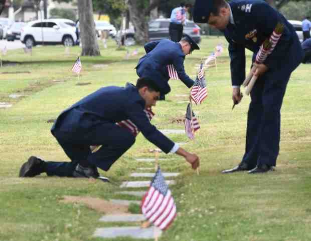 Air Force young cadets put flags on veterans grave sites...