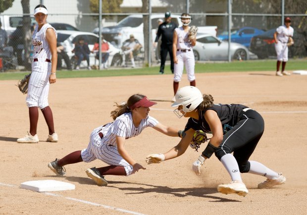 Valley Chistian’s Lydia Dietz tags out Providence’s Delailah Lopez as...