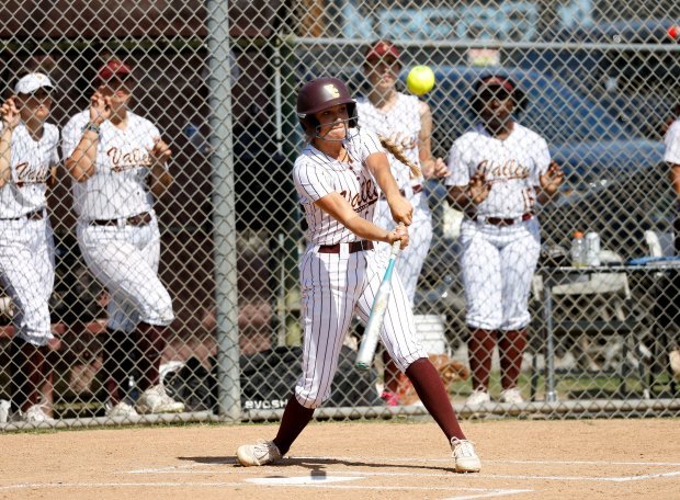 Valley Christian’s Britton Brown gets a hit as they take...