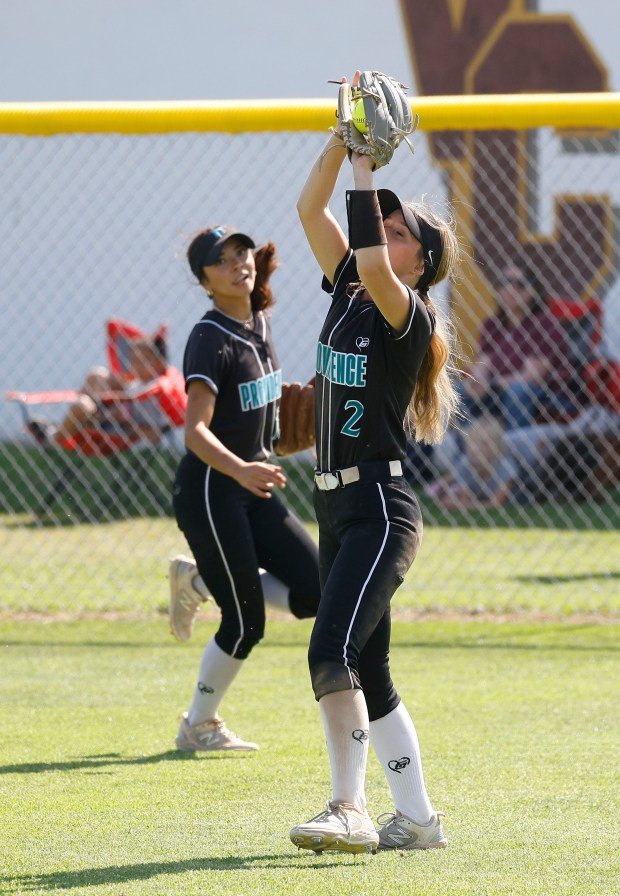 Providence’s Mia Allinson grabs the out as they take on...