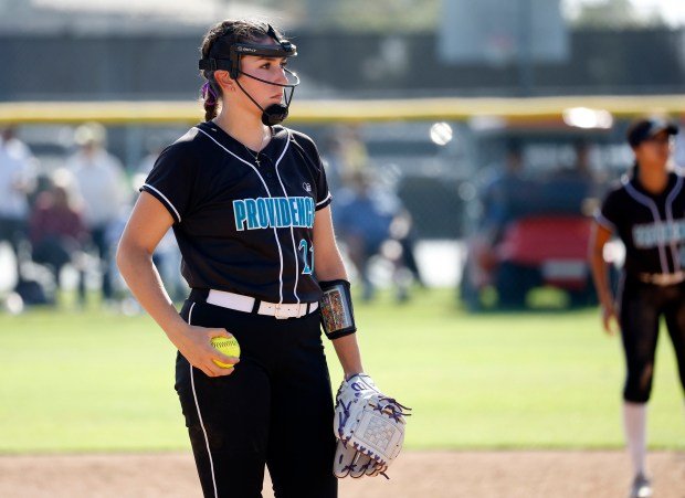 Providence’s Olyvia Rutter anticipates her next pitch as they take...