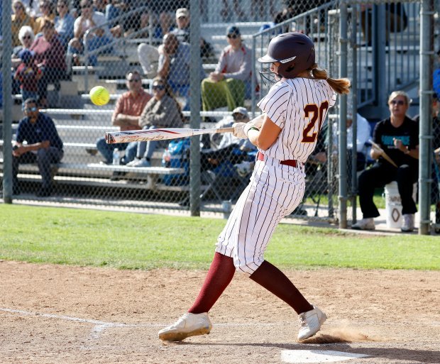 Valley Christian’s Peyton Kingery gets the hit as they take...