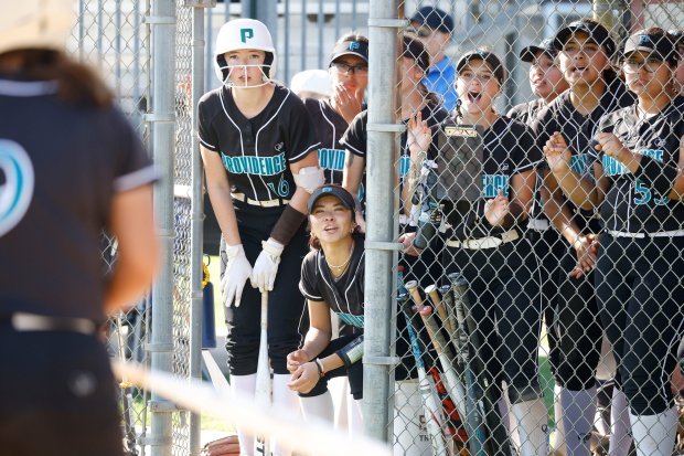 Providence teammates cheer on their batter as they take on...