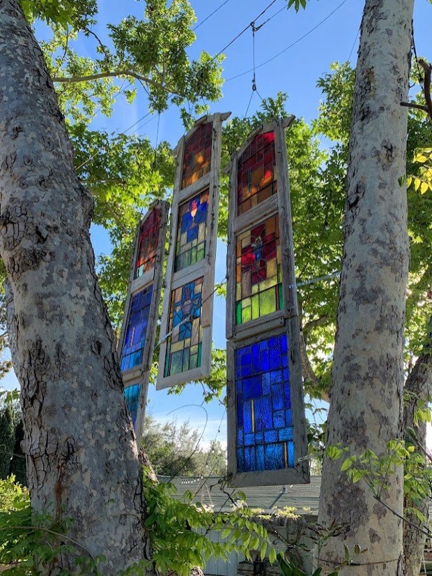 Stained glass windows hand above the outdoor dining area at...