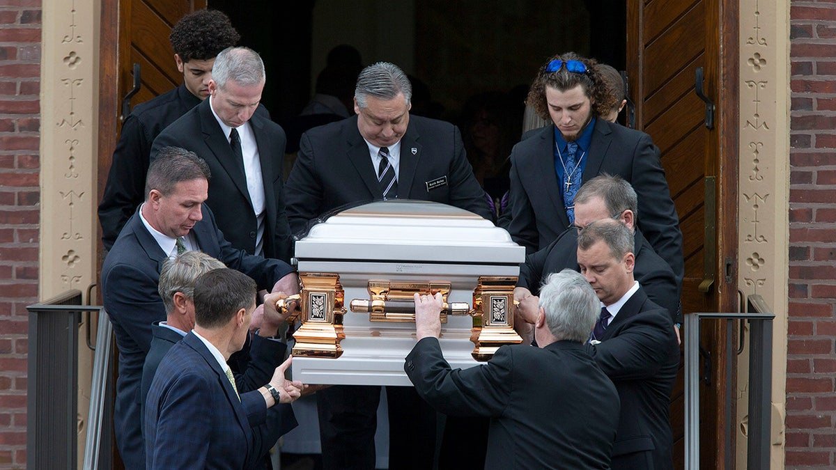 Stephanie Parzes casket being carried by several men.