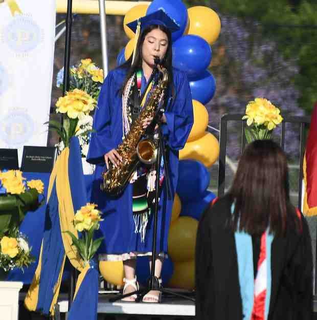 Playing the National Anthem on the saxophone is grad Esmeralda...