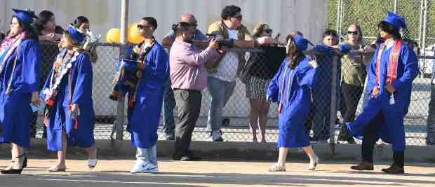 Parents get photos during the 2024 Poly High graduation Tuesday...