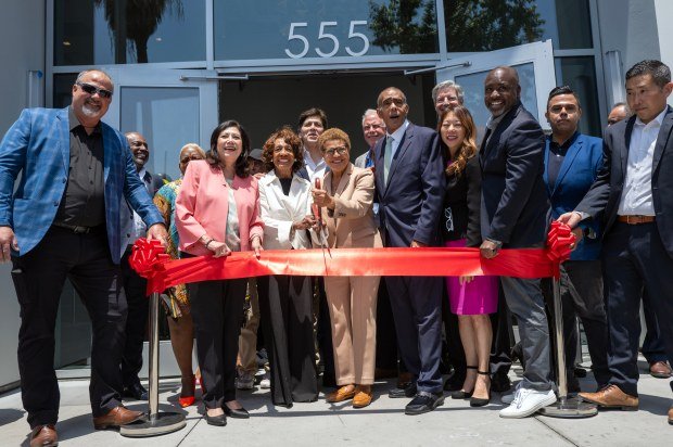 Dignitaries cut a ribbon during a grand opening ceremony on...