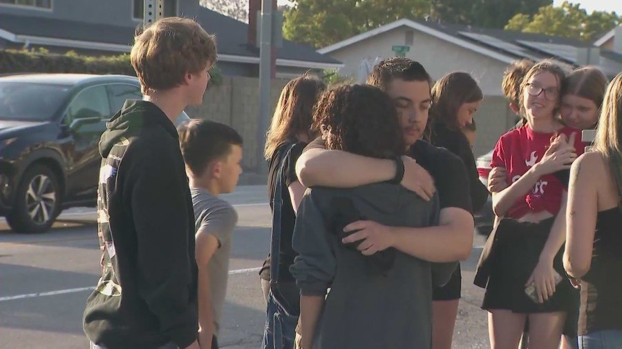 Friends, classmates and loved ones gathered at a makeshift memorial near the crash site to Honor Zach Henn in Placentia on June 4, 2024. (KTLA)