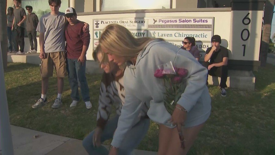 Friends, classmates and loved ones gathered at a makeshift memorial near the crash site to Honor Zach Henn in Placentia on June 4, 2024. (KTLA)