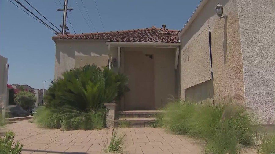 A West Hollywood home remains boarded up on July 2, 2024 after a large fire  was ignited amid complaints of squatters constantly trespassing. (KTLA)