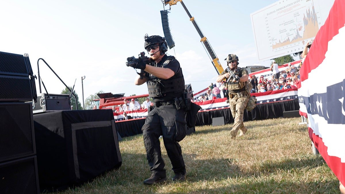 Law enforcement officers move during a rally