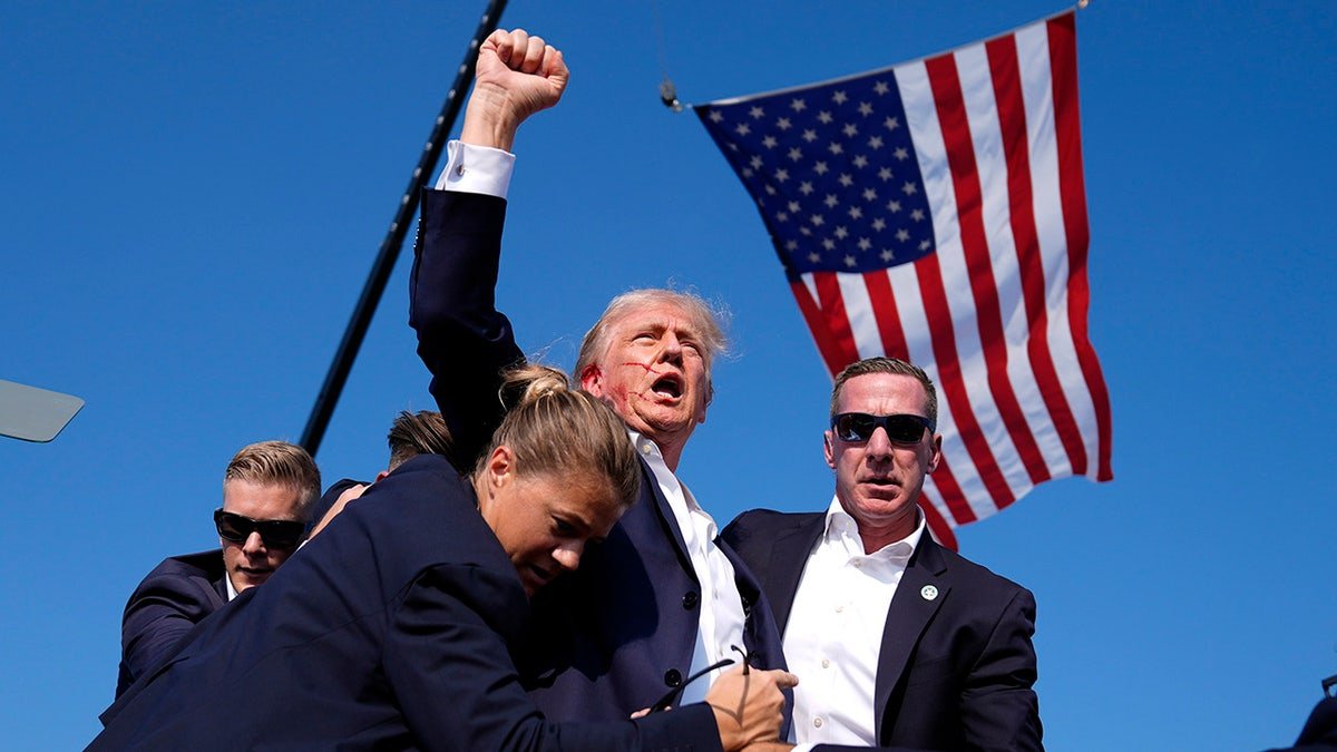 Donald Trump is surround by U.S. Secret Service agents at a campaign rally