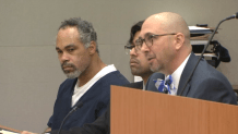 Parrish Chambers, Jr. (left), sits next to members of his legal defense team, including his public defender.