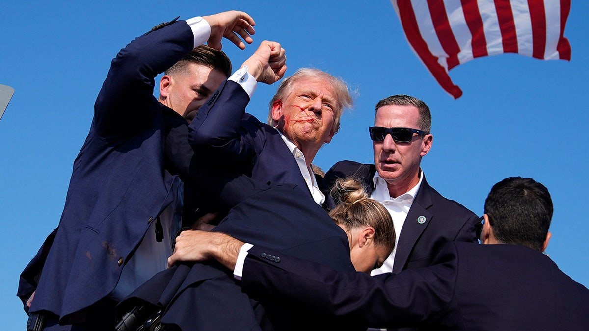 Republican presidential candidate former President Donald Trump is surrounded by U.S. Secret Service agents at a campaign rally