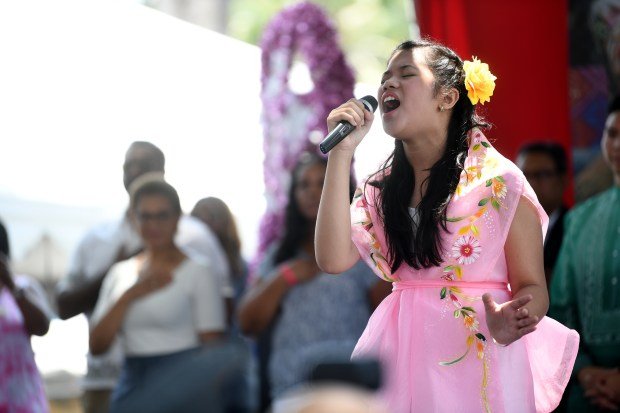 Isabella Loyola performs the National Anthem during opening ceremonies for...