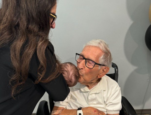 Morris Savich and his daughter Linda Alper. Morris is kissing...