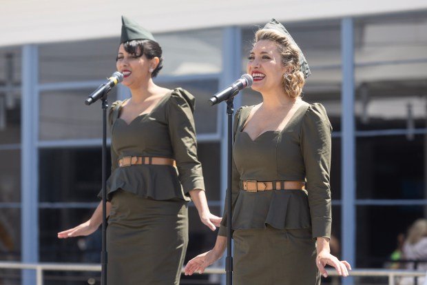 Members of the Hollywood Dolls perform during the reopening celebration...