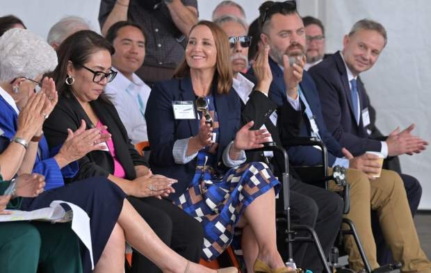 The crowd applauds as officials gathered to break ground on...