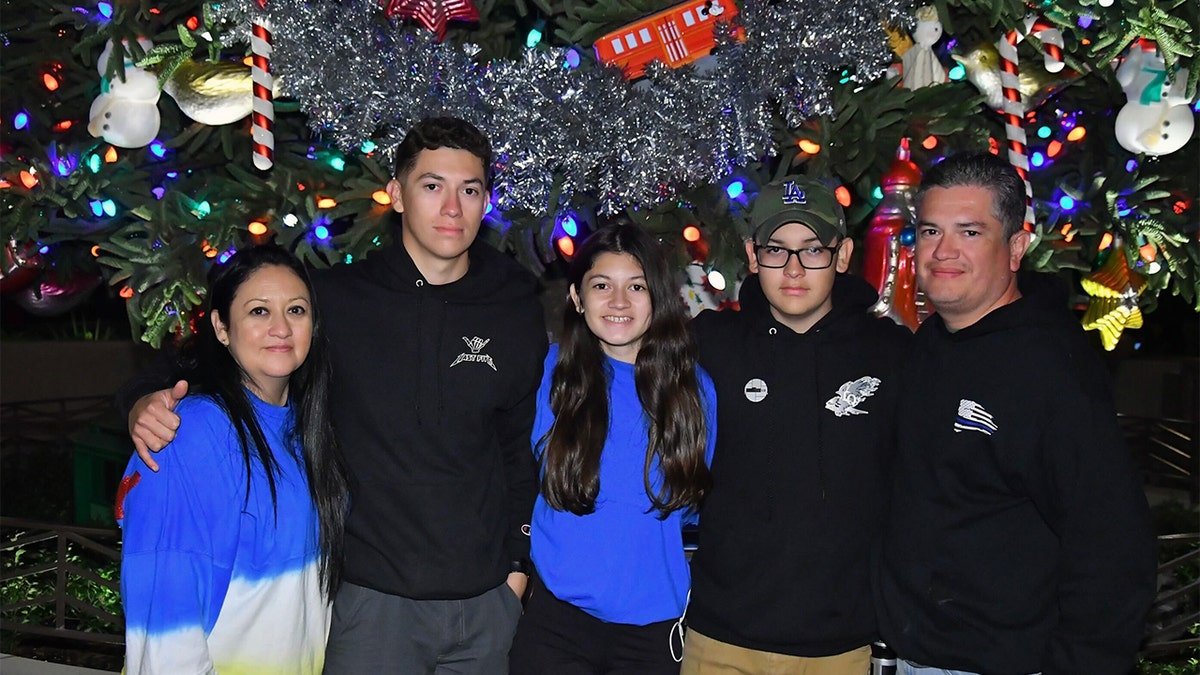 The Lopez family stands together at Christmastime