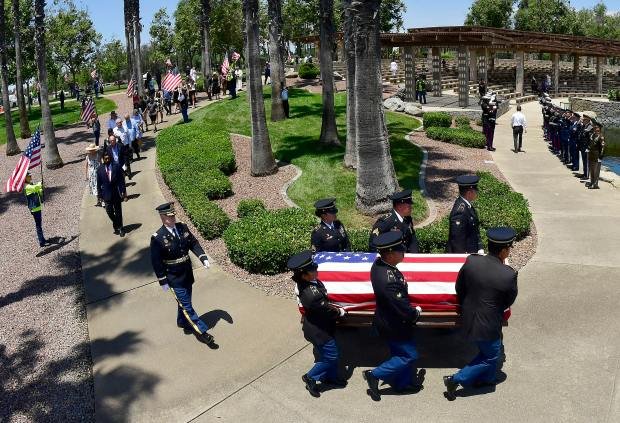 An honor guard carry the casket of U.S. Army Air...