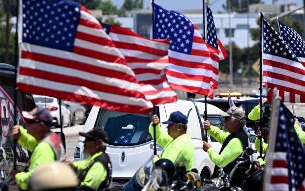 Members of the Patriot Guard show their respect as the...