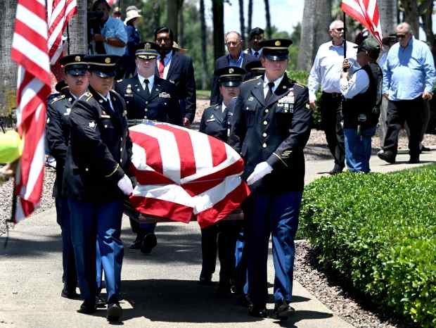 An honor guard carry the casket of U.S. Army Air...