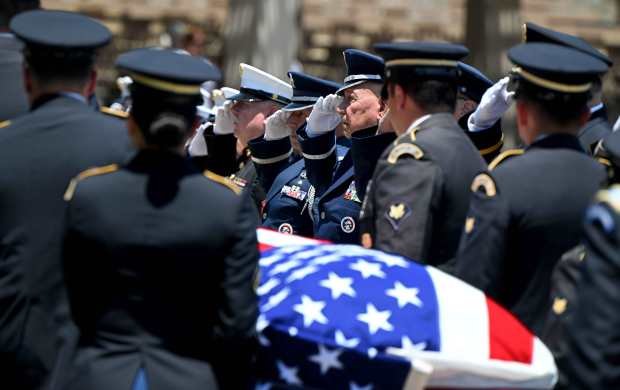 An honor guard carry the casket of U.S. Army Air...