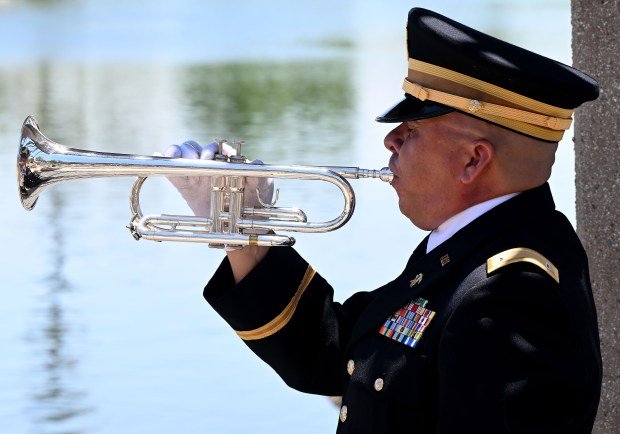 Gabriel Gamez, from Adelanto, plays Taps during funeral services for...