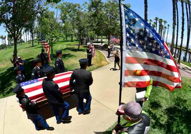 An honor guard carry the casket of U.S. Army Air...