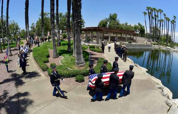 An honor guard carry the casket of U.S. Army Air...