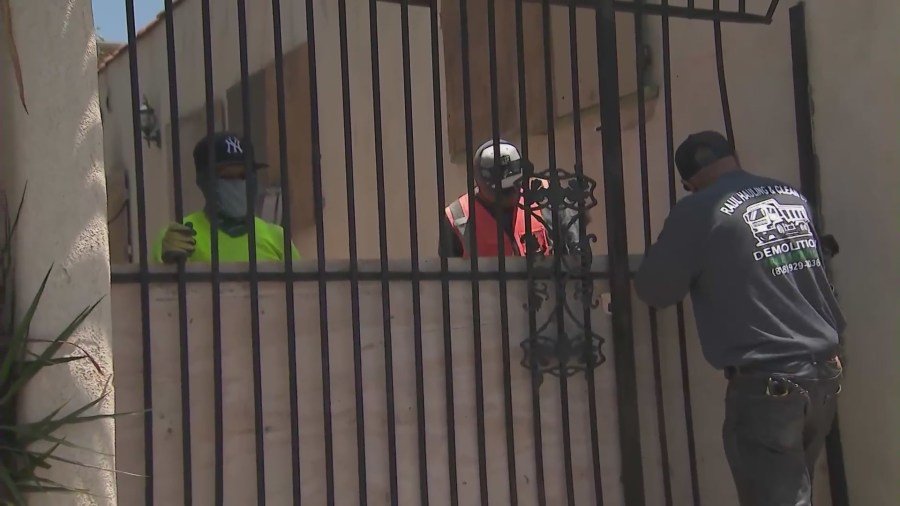 Workers boarding up a West Hollywood home on July 2, 2024 after complaints of squatters constantly trespassing. (KTLA)