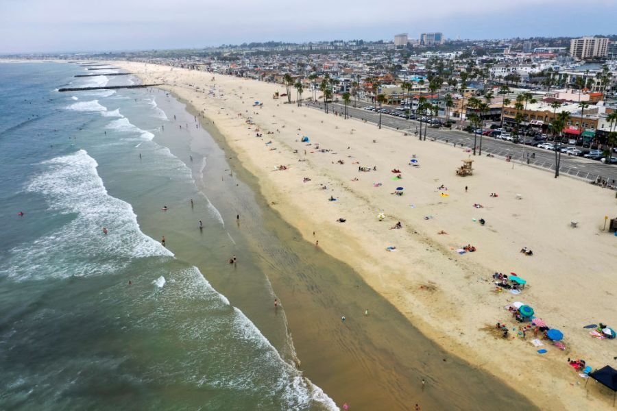 An aerial view of beachgoers enjoying a partially-sunny, warm day on the beach near the pier in Newport Beach, CA, on April 28, 2020. (Allen J. Schaben / Los Angeles Times via Getty Images)