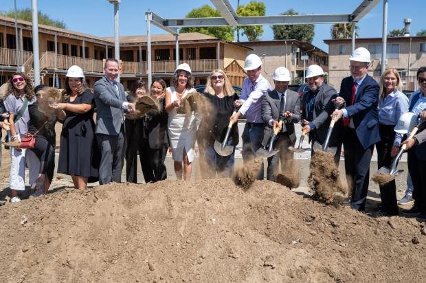 Dignitaries shovel dirt during a groundbreaking ceremony for The Pano,...