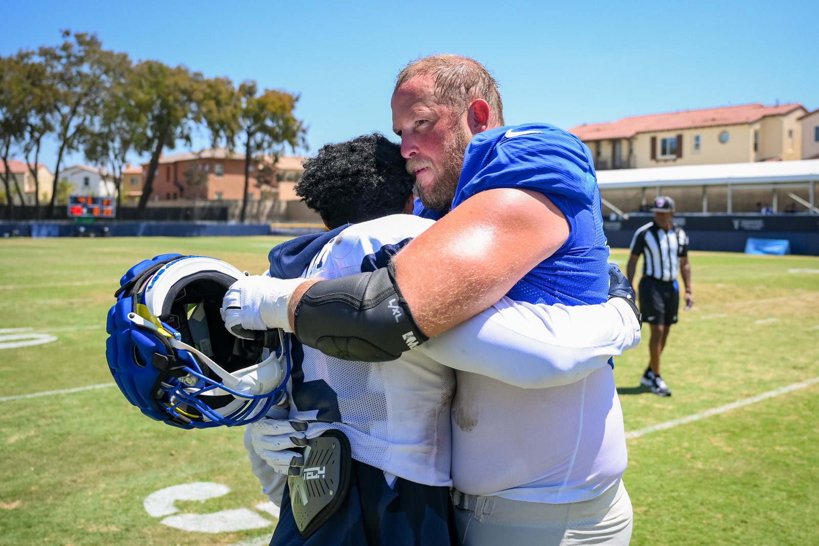 Rams offensive lineman Conor McDermott, right, hugs Dallas Cowboys running...