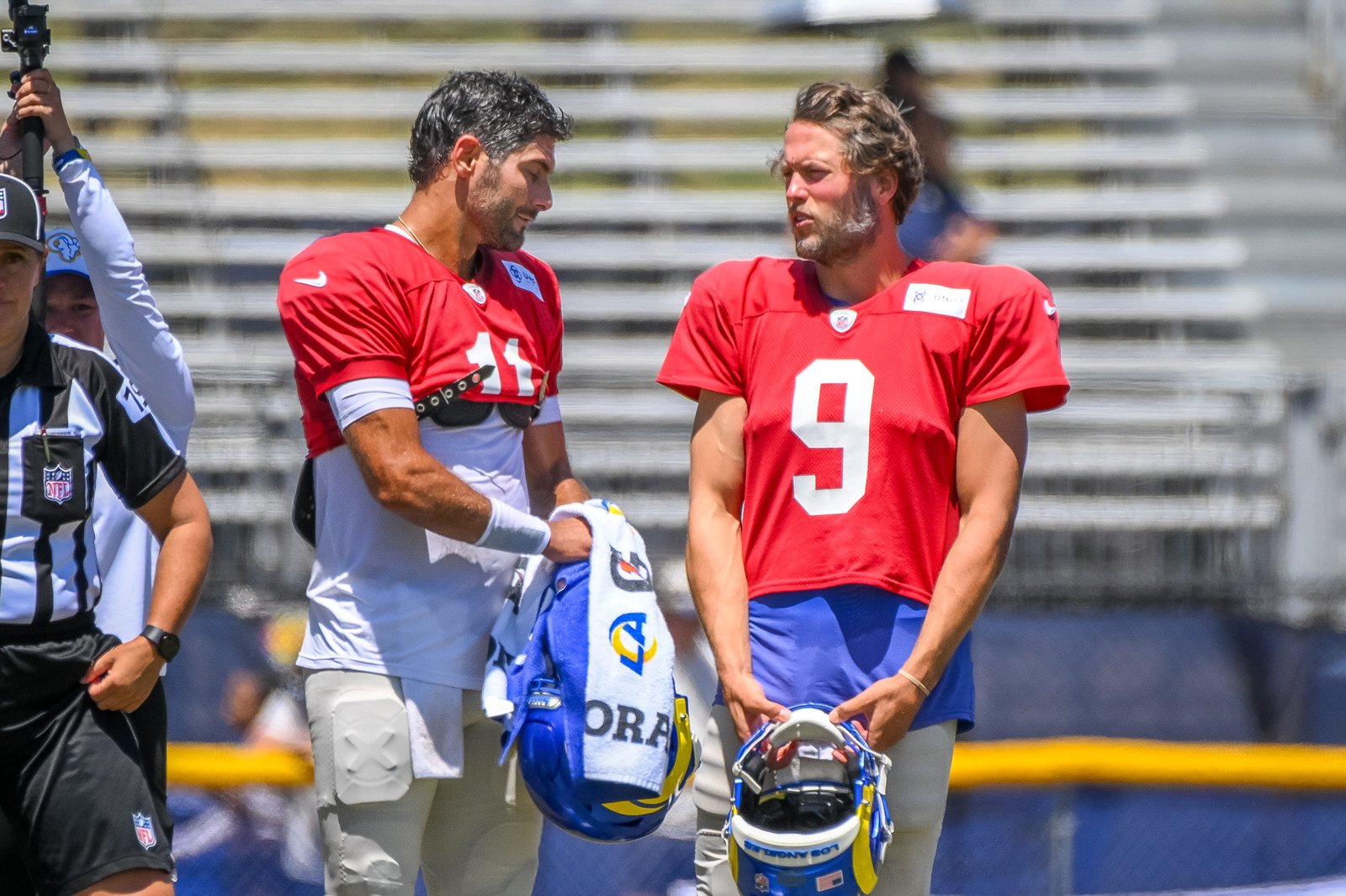 Rams quarterbacks Jimmy Garoppolo, left, and Matthew Stafford (9) talk...